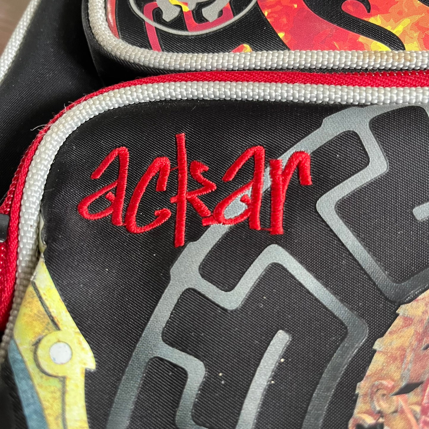 Lego Bionicle 2010 Glatorian Gresh Backpack made by Class Investment in 2010, featuring a front pocket with an embroidered Glatorian Ackar figure and text. The top pocket includes both Bionicle and LEGO logos, along with custom rubber zipper pulls. Finished with two side bottle pockets and additional Bionicle logo details, making it a great rare collectible for fans of the series.