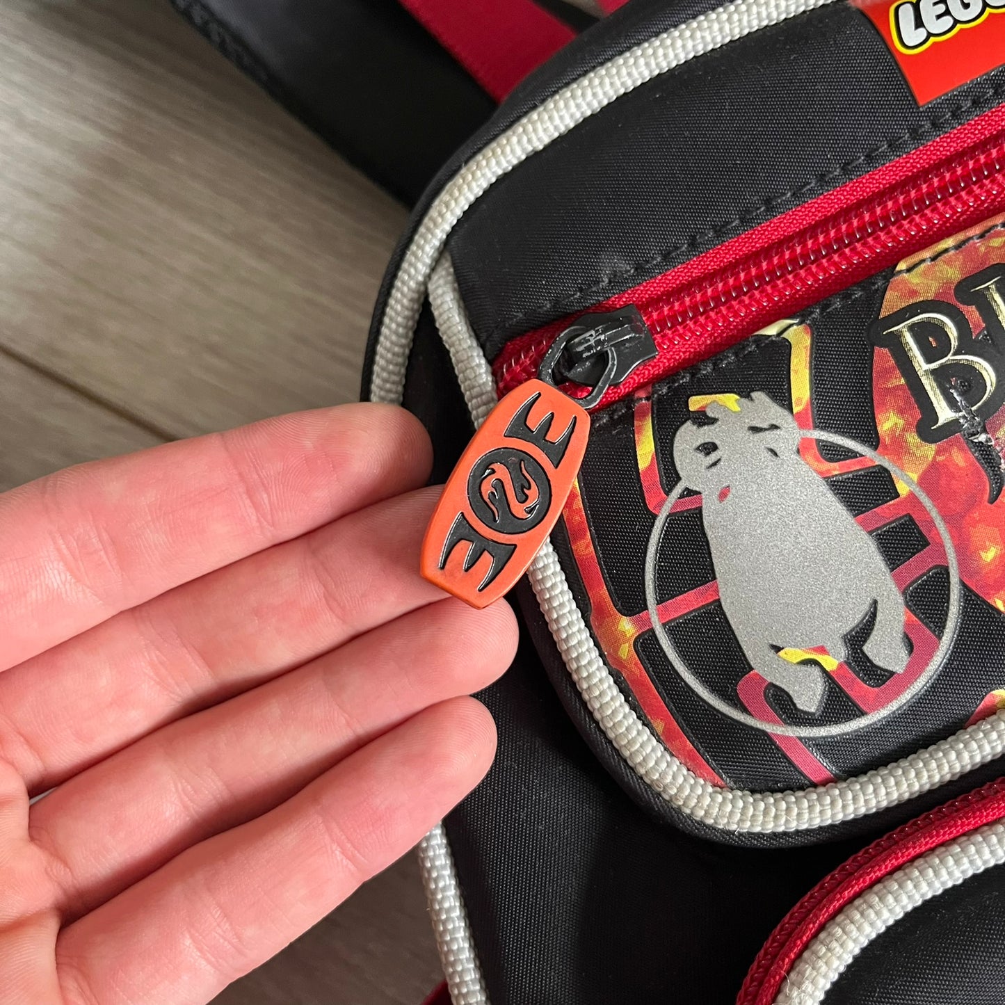 Lego Bionicle 2010 Glatorian Gresh Backpack made by Class Investment in 2010, featuring a front pocket with an embroidered Glatorian Ackar figure and text. The top pocket includes both Bionicle and LEGO logos, along with custom rubber zipper pulls. Finished with two side bottle pockets and additional Bionicle logo details, making it a great rare collectible for fans of the series.