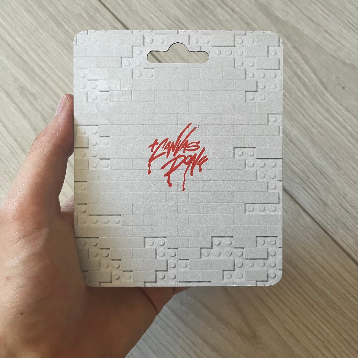 Lego Playboi Carti “Whole Lotta Red” minifigure featuring the Carti with red dreads from the album era. The figure is displayed on a paper/cartboard display accompanied by a small plate of the Lego style album cover, a limited addition only for first orders. A collectible piece from TheCanvasDon.