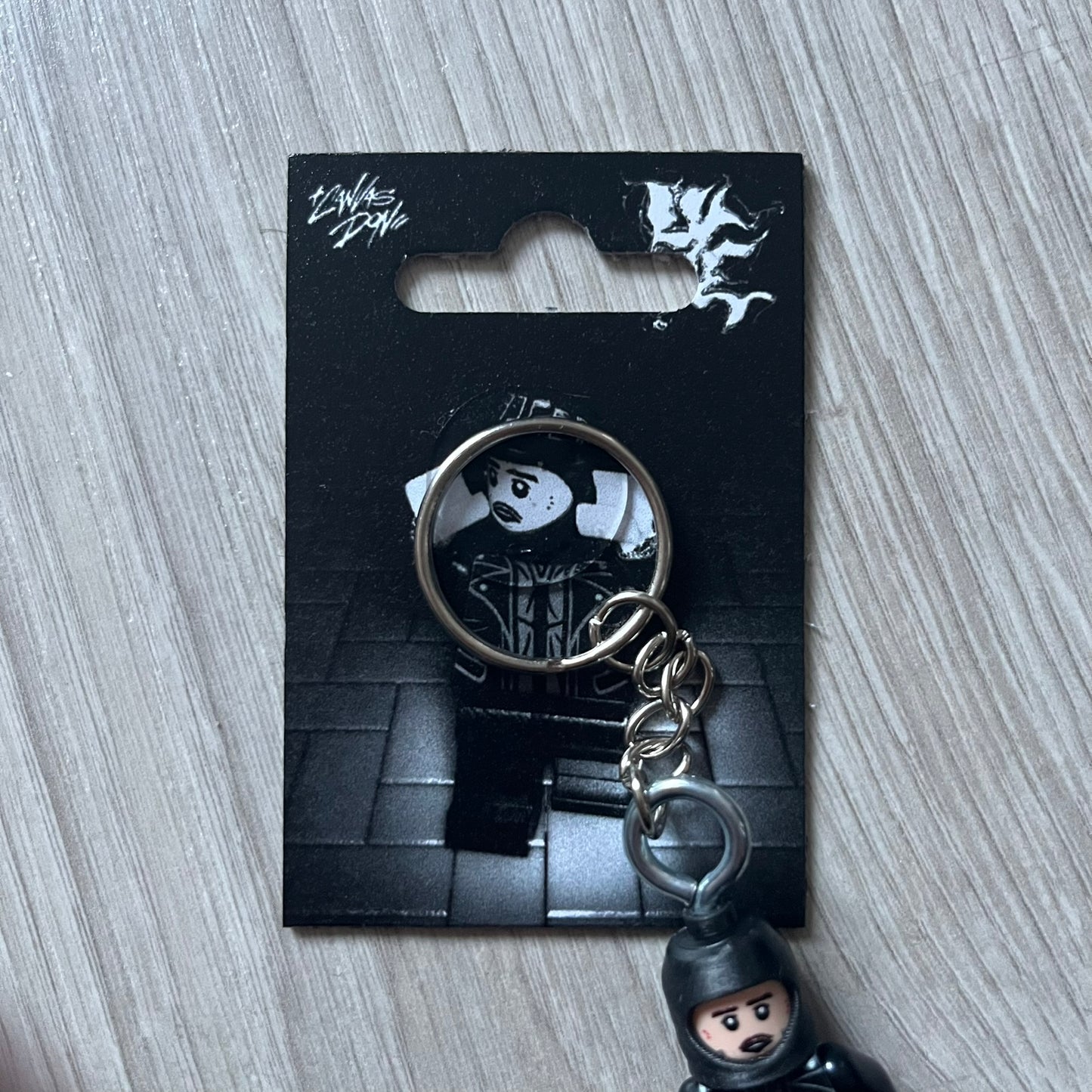 Lego Yeat 'Brick Lyfe' keychain featuring a custom Lego figure of Yeat with his black jacket and a black balaclava. The figure is attached to a Lego-style recreation of the 2022 Lyfe EP cover, reimagined in brick graphics. A playful and creative collectible that merges music culture with fan-made Lego artistry, made by TheCanvasDon.