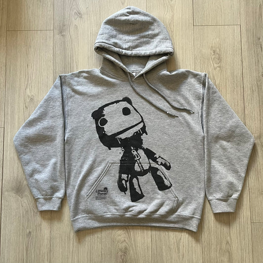 Ultra-rare Little Big Planet hoodie from 2010, made on a Gildan Heavy Blend. Showcases a graffiti like print with Sackboy and logo LBP branding on the pocket with Sony/SCEE licensing. This piece is nearly impossible to find today, making it a standout collectible for fans.