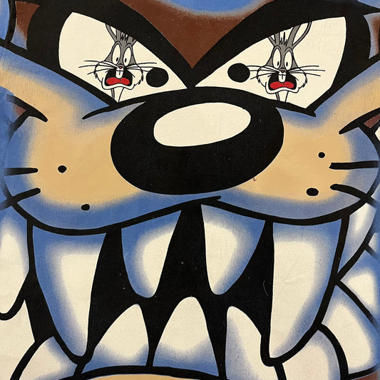 Looney Tunes “Taz & Bugs Bunny” 1997 Freeze Tee featuring a blue base with an all-over front print. The graphic shows Taz with an angry expression and Bugs Bunny reflected in his eyes, with 1997 Warner Bros. Freeze licensing printed below. Made in the USA from 100% cotton.