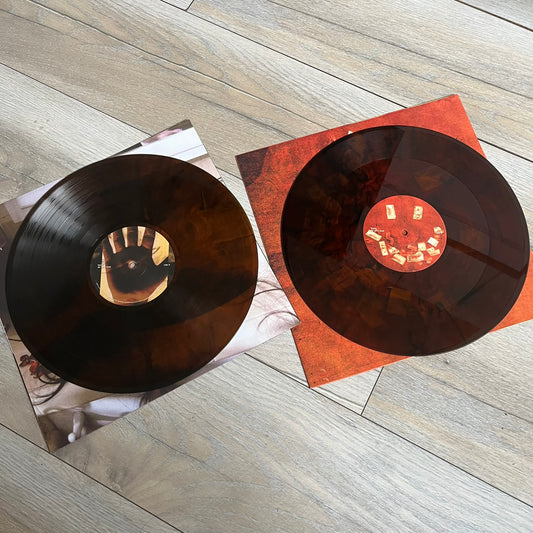 Lucki Drgs R Bad* 2026 Signed BRAZY 4 LUCKI Vinyl is a 2xLP release of Lucki’s fourth studio album, originally released on May 15, 2026. The set includes alternative front and back artwork, a widespine jacket, and printed inner sleeves with different graphics for each record. The vinyl records are transparent orange with black smoke effects throughout. The outer jacket features artwork of a girl shaving her head with the DRB logo cut into her hair. This copy is signed by Lucki in the upper left corner with