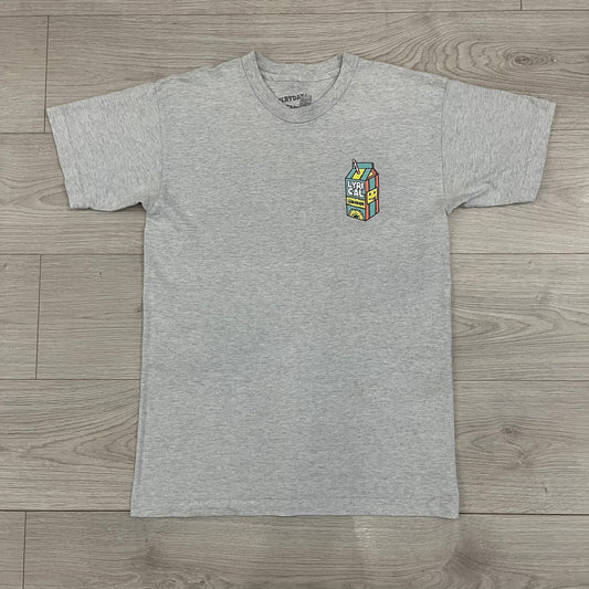 Lyrical Lemonade Everyday Essentials Gray T-Shirt in a gray colorway. Features a small Lyrical Lemonade carton graphic with an xP face printed on the left chest. The back displays a large Lyrical Lemonade logo with text and carton graphics in blue, yellow, and pink, from the Everyday Essentials line.
