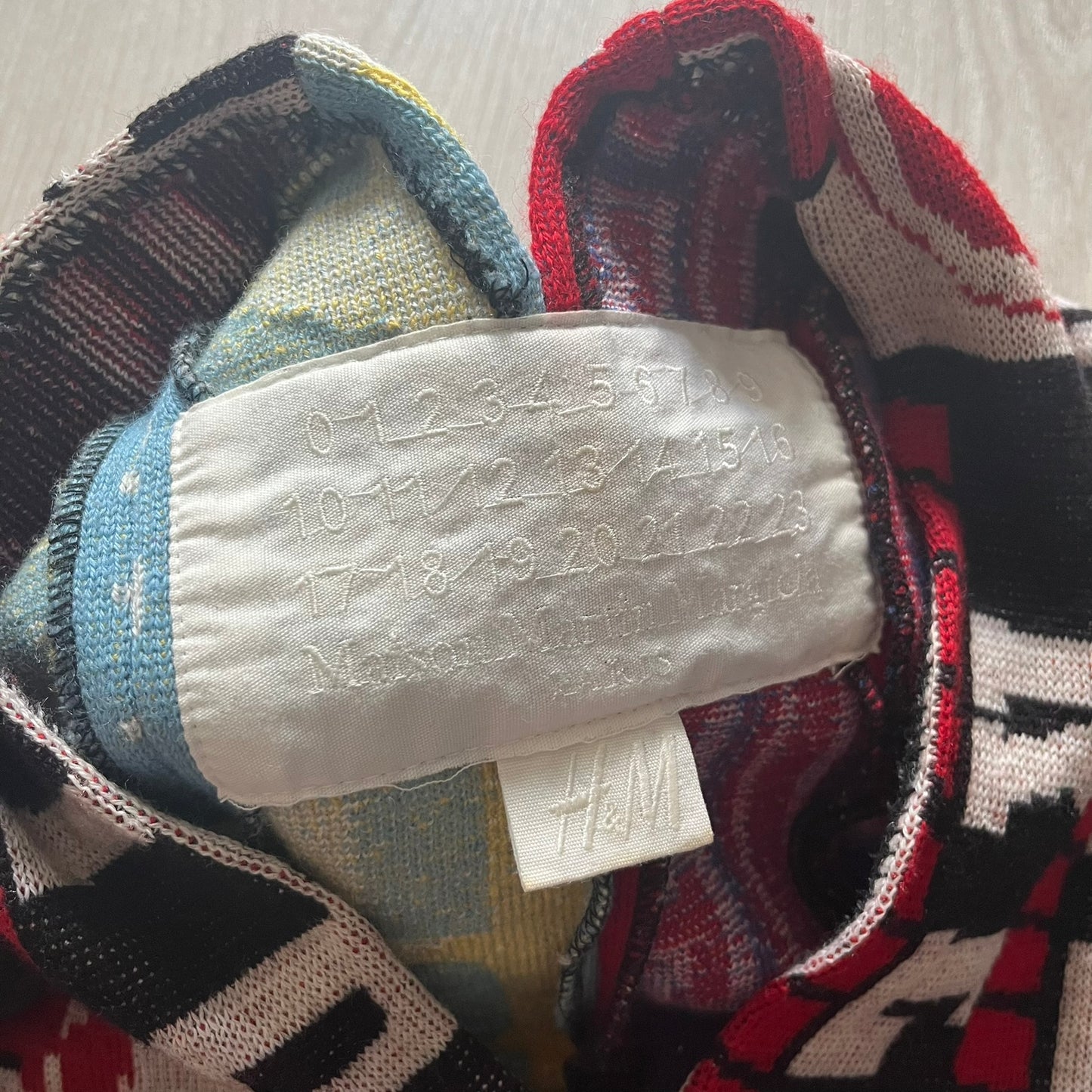 Colorful fabric with an H&M label on a neutral background