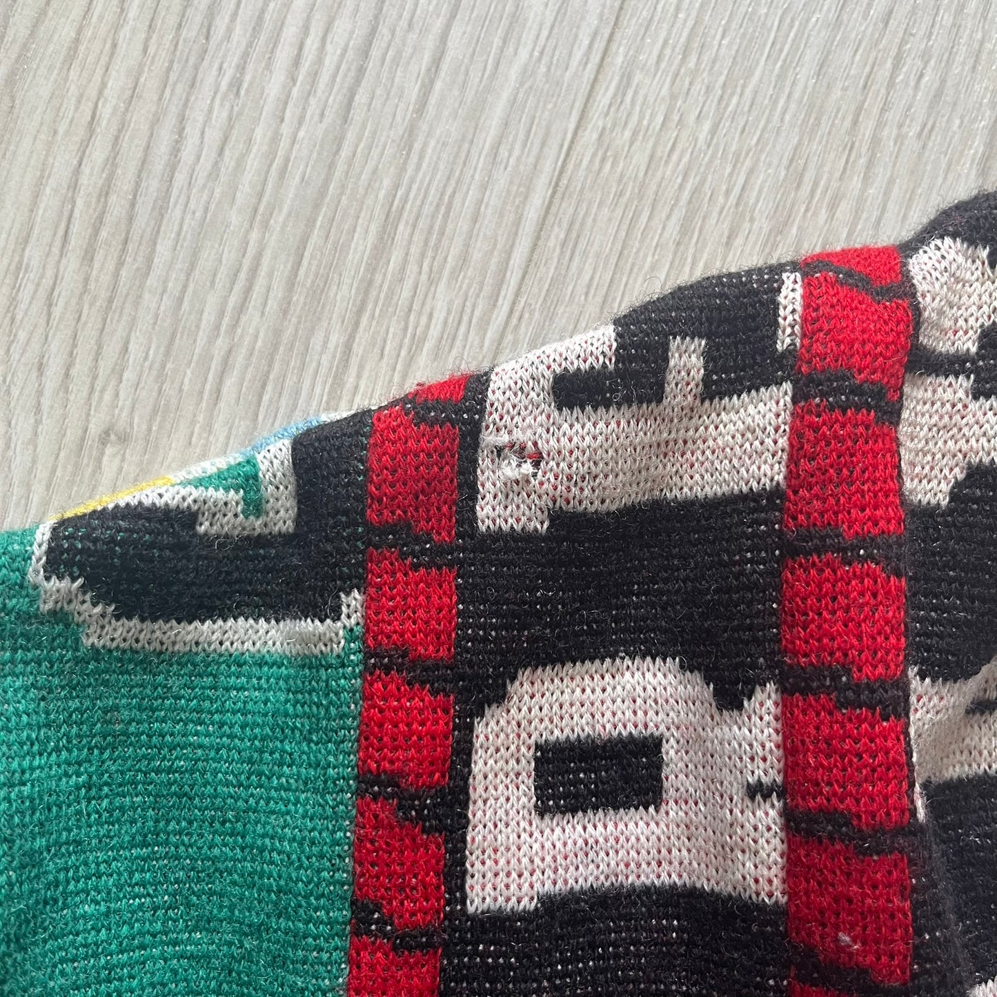 Close-up of a knitted fabric with geometric pattern on a textured background