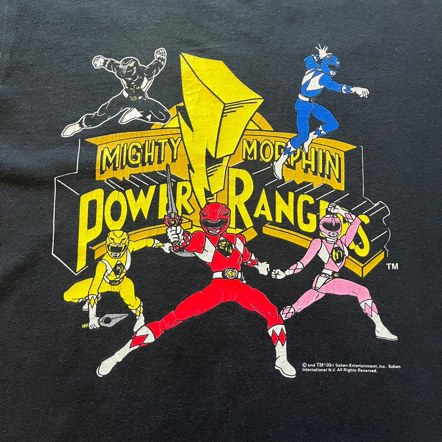 1994 Power Rangers tee with striking full-team graphic, officially licensed by Saban Entertainment. Crafted on a Delta USA-made blank with single stitch finish for authentic vintage feel. Perfect for fans and collectors of classic ‘90s TV.
