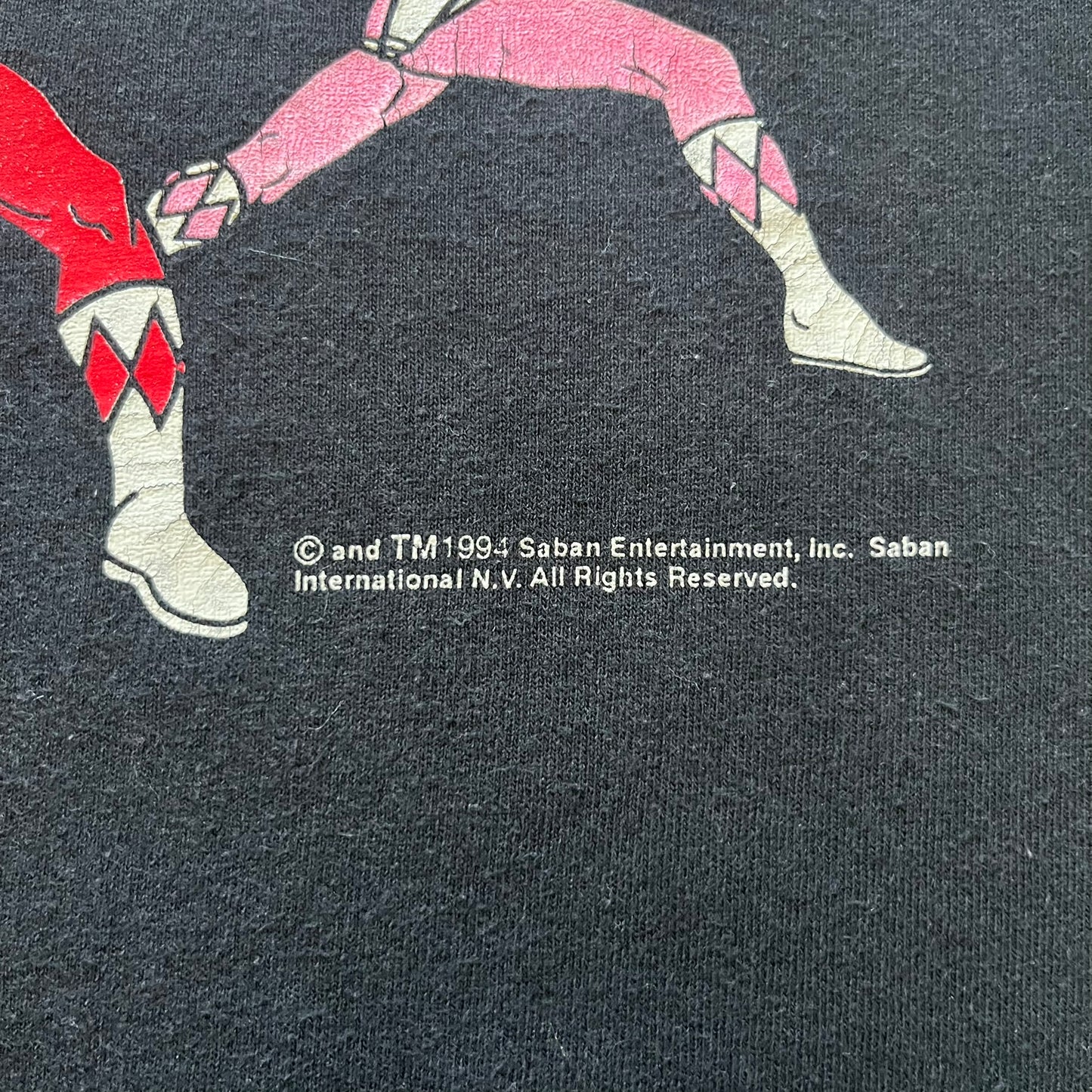 1994 Power Rangers tee with striking full-team graphic, officially licensed by Saban Entertainment. Crafted on a Delta USA-made blank with single stitch finish for authentic vintage feel. Perfect for fans and collectors of classic ‘90s TV.