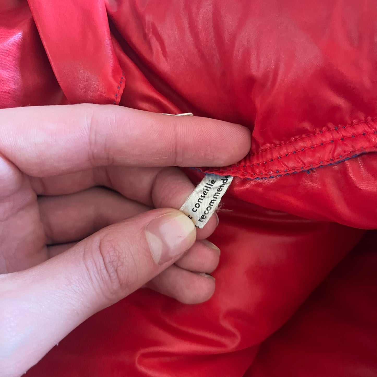 Vintage 1980s Moncler Grenoble down jacket in blue with a contrasting red lining. Features a foldable thin hood hidden in the back, silver-tone buttons and zippers, and the original Moncler patch on the sleeve. A rare French-made piece with authentic Grenoble labels, distinct from the brand’s modern ski line.
