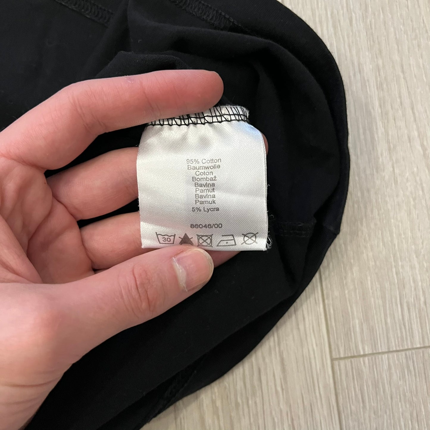 Monster Energy Eyes Tee in black, featuring a graphic of a woman’s eyes with the Monster logo and text on the front in gray and white tones. Green shoulder stitching and a Monster Energy logo on the back under the collar. Made from 95% cotton and 5% Lycra.