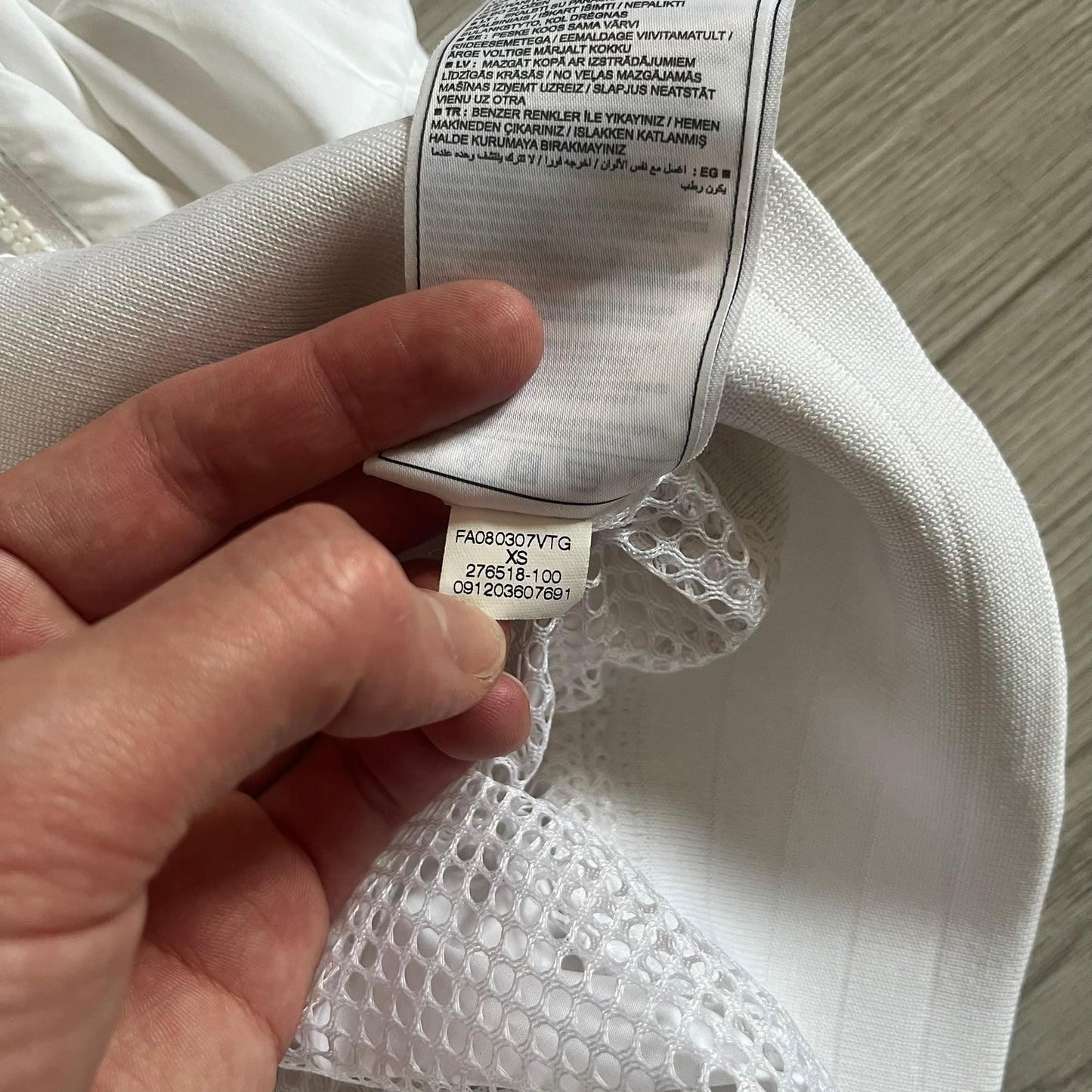 Nike Japan Olympics Split Windbreaker from 2008, created by designer Jarrett Reynolds. Crafted in white with a large red circle representing Japan’s flag, this innovative jacket can be zipped apart on both sides and merged with other compatible models. Hidden inside, a small Japan flags accent completes the concept.