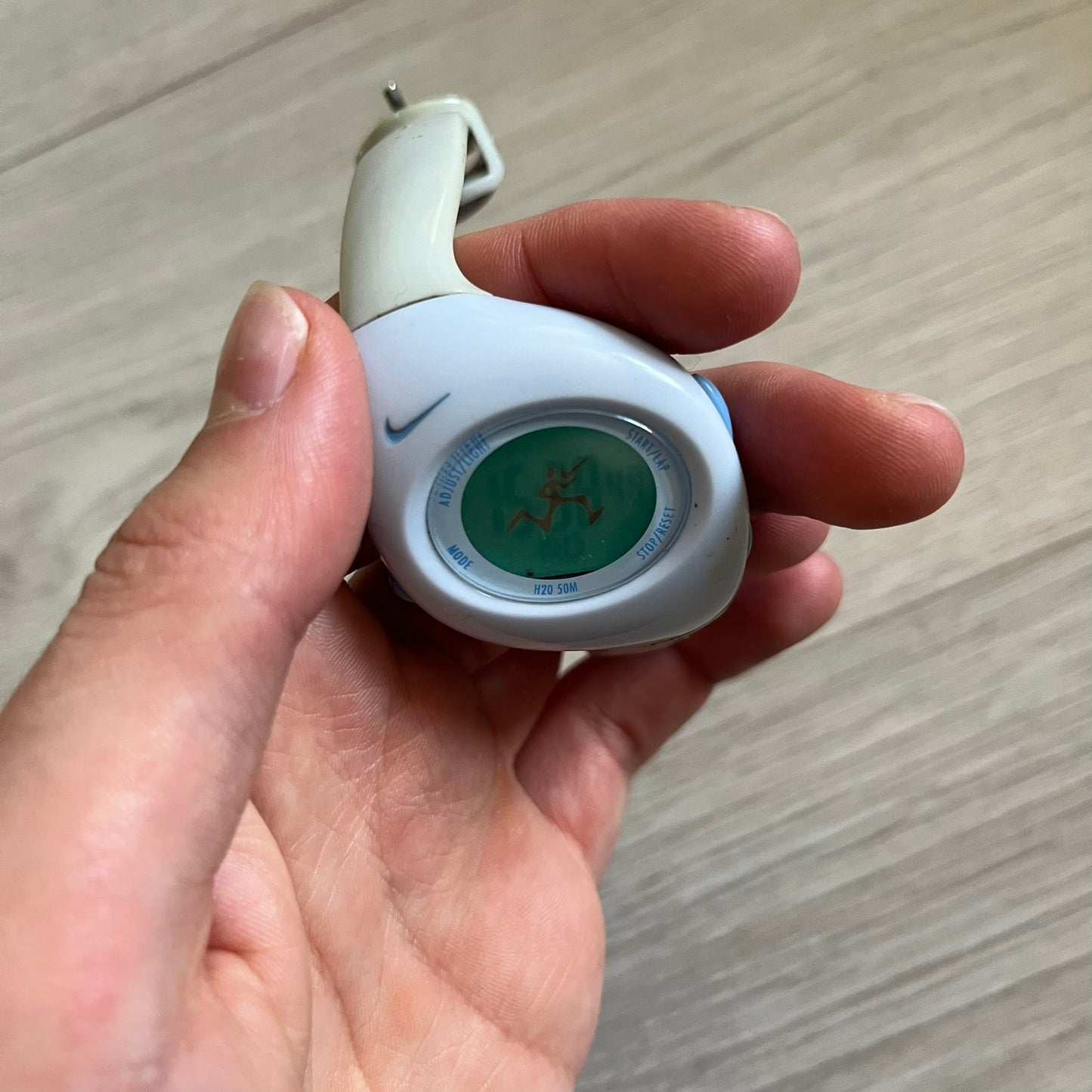 Rare late-1990s Nike Triax Roar J digital watch in a white/milky colorway with blue accents. Features an asymmetrical, ergonomic case and sporty design with a milky rubber band. The strap was broken so it needs fixing, making this either for display or restoration.