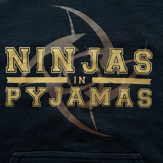 Ninjas In Pyjamas 2010’s Black Hoodie featuring the classic brown NIP logo with gold “Ninjas in Pyjamas” text across the front. Made on a Gildan Heavy Blend blank with a front pocket and adjustable hood. A vintage piece representing one of CS:GO’s most iconic teams.