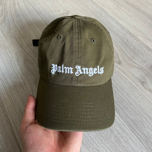 Palm Angels Classic Logo Khaki Baseball Cap made from 100% cotton with white embroidered Palm Angels lettering on both the front and back. Designed with gothic-inspired typography, this cap delivers a clean, minimal look with a streetwear edge.