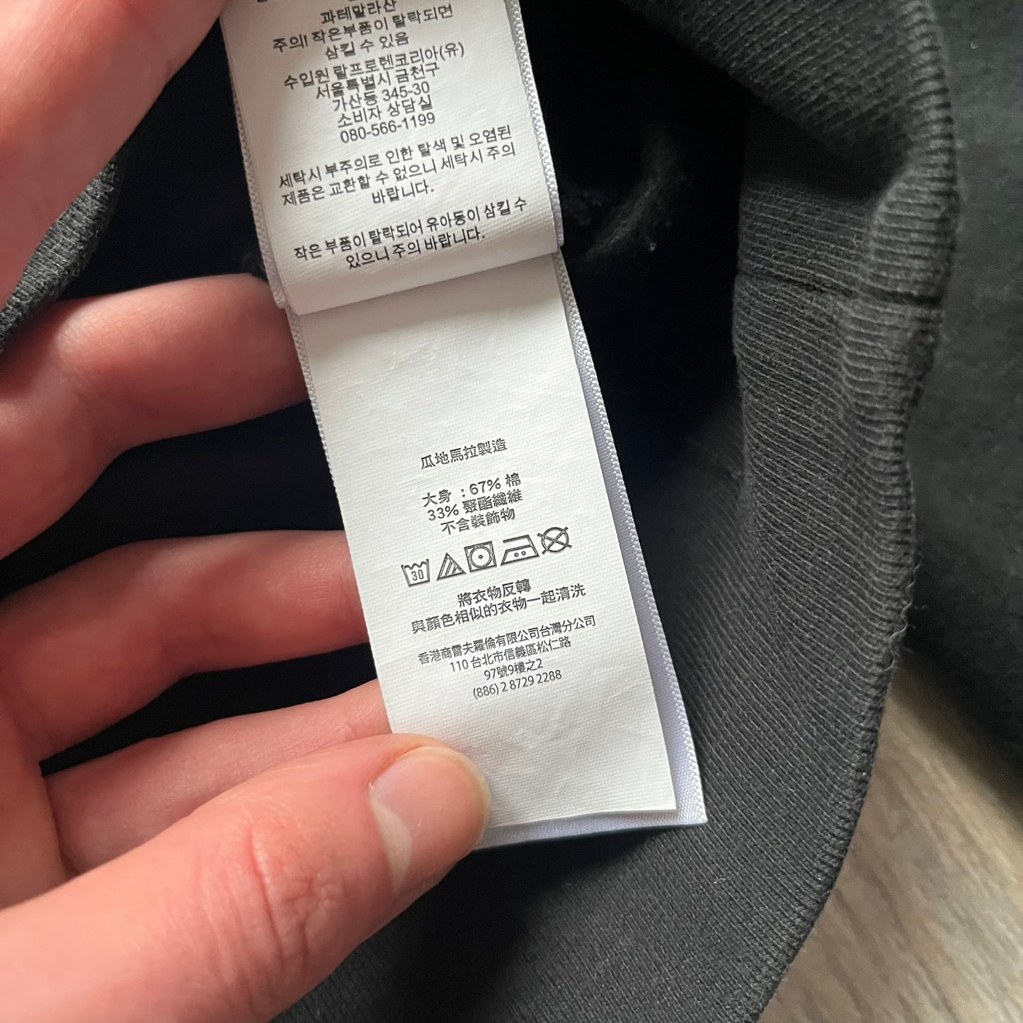 Polo Ralph Lauren x Fortnite black hoodie featuring a detailed embroidered purple Fortnite llama with the RL rider logo placed on top. Made from a 66% cotton and 34% polyester blend, it has a classic pullover construction with an attached hood and front kangaroo pocket. The embroidery is positioned on the left chest and stands out with clean stitching and sharp detail.