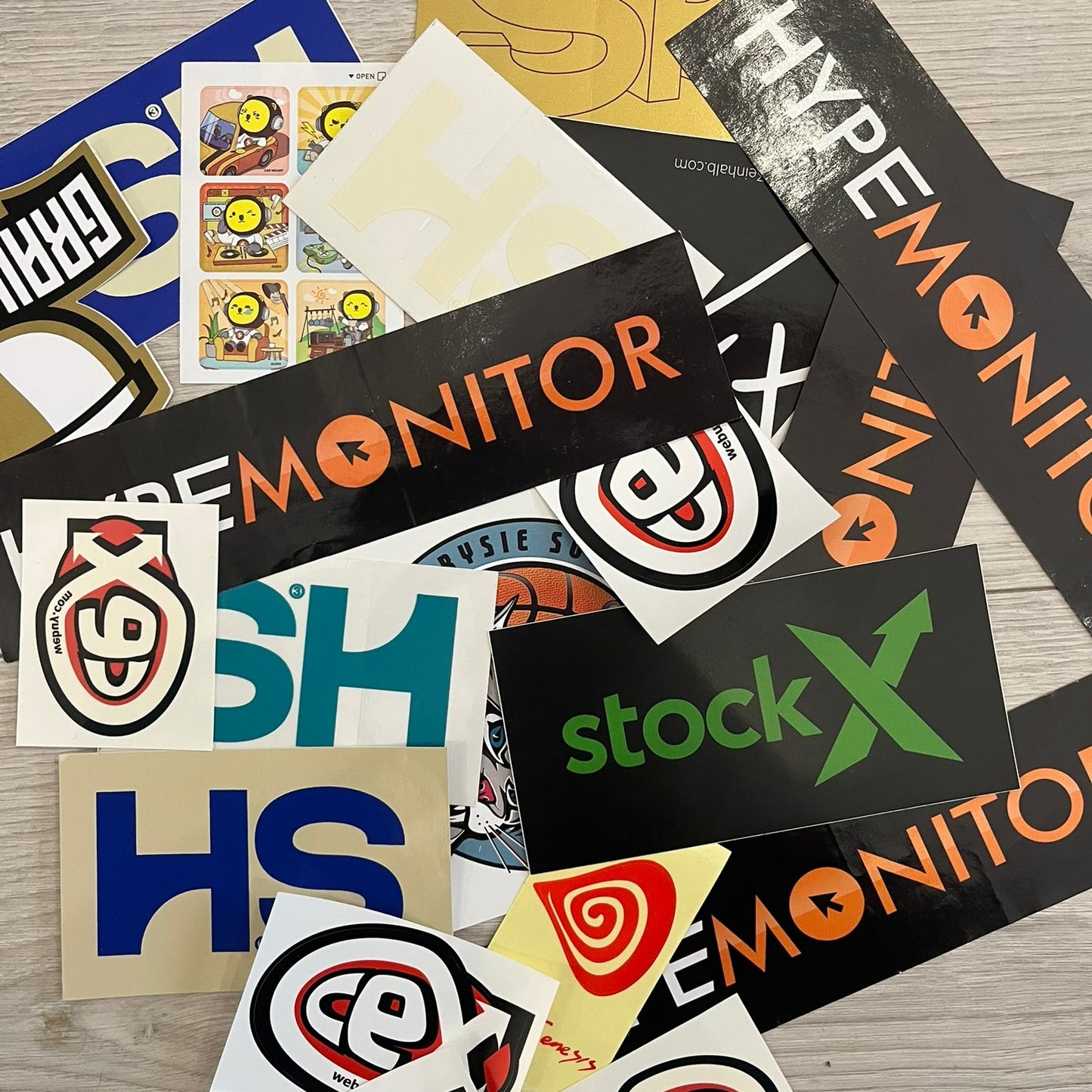 A collection of various stickers including brand logos and abstract designs.