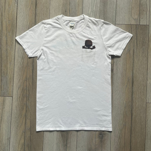Sackboy: A Big Adventure 2020 White Promo Tee is a white cotton T-shirt featuring official Sony licensing and a “not for sale” internal tag. The front includes a small printed faux chest pocket design with Sackboy waving from inside it. The upper back displays a large “Sackboy: A Big Adventure” game logo print.