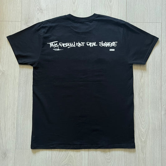 Black Batpreme tee designed by Slawn with Supreme Box Logo and his iconic Batman graphic on the front. Printed neck tag with signature and back shows handwritten-style text saying “This really isn’t real Supreme” with Slawn signature and the Supreme bogo. A rare, art-driven streetwear essential.
