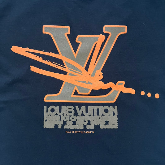 The Slawn LV Black Tee, given away at the Paris Pop-up in 2024, features a orange-brown LV logo on the front. Despite the branding, this is a Slawn creation, not an official Louis Vuitton piece.