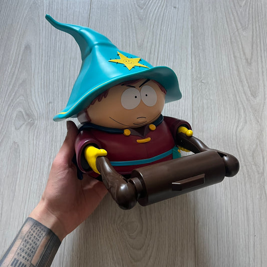 Unique South Park Snow Day exclusive featuring Grand Wizard Cartman as a talking toilet paper holder. The figure delivers iconic quotes while the roll turns, complete with a wooden-style holder design. A must-have collectible for South Park enthusiasts.