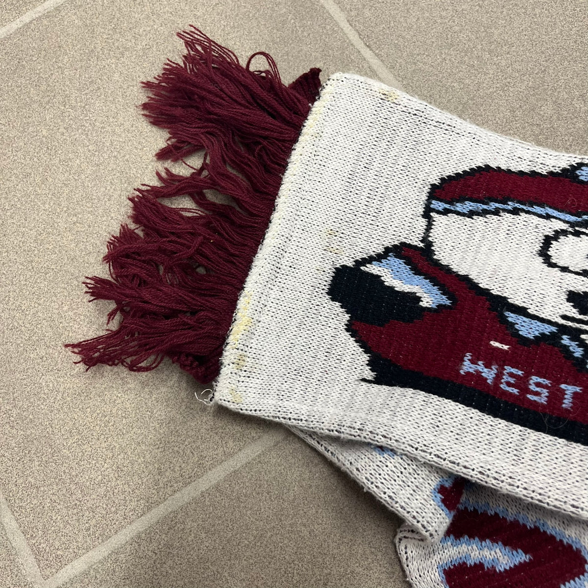 Vintage South Park West Ham 1990's Football Scarf in white and burgundy with fringe / tassels, featuring South Park characters including Kenny, Cartman, Kyle and Stan dressed in West Ham kits. The character graphics appear on both sides of the scarf, with consistent coloring in Burgundy and light blue.