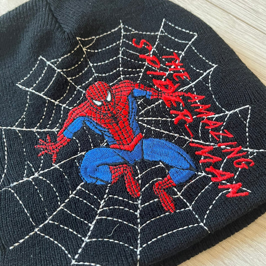 Embroidered Spider-Man design on a black fabric background