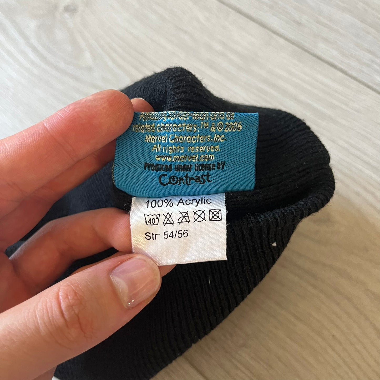 Close-up of a label on a black sock with text and symbols.
