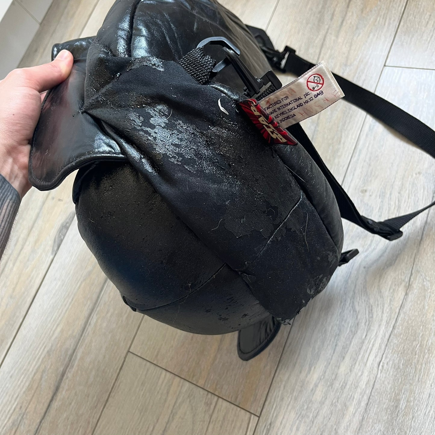Star Wars 1990s Darth Vader Head Backpack is a vintage backpack shaped like Darth Vader’s helmet. It is finished in shiny black with molded plastic details recreating the character’s mask and helmet. The bag has one main compartment and includes a red Star Wars licensed tag from the 1990s.
