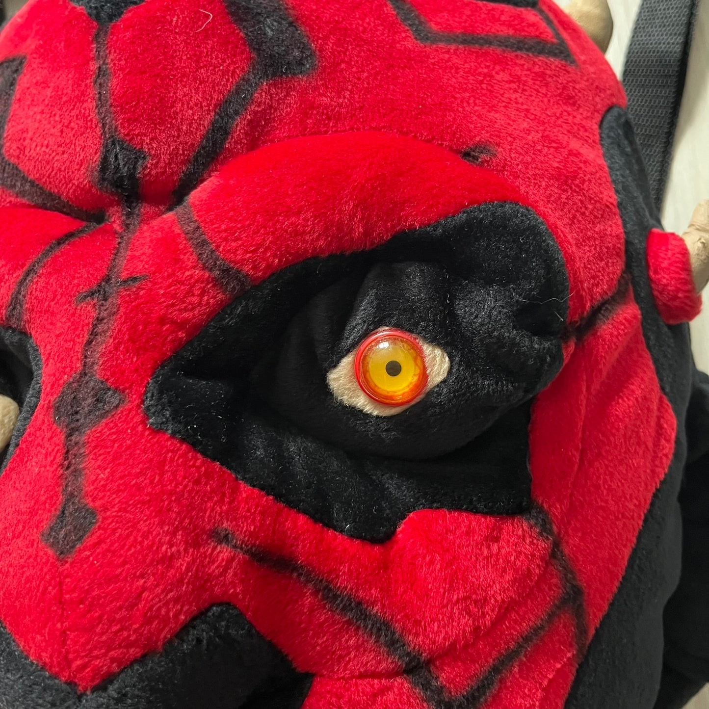 Star Wars 90's Darth Maul Head Backpack - a plush backpack shaped like Darth Maul’s head with striking red-and-black detailing and realistic plastic eyes. Features a small zip compartment on the back and adjustable straps, perfect as a collectible or standout accessory.