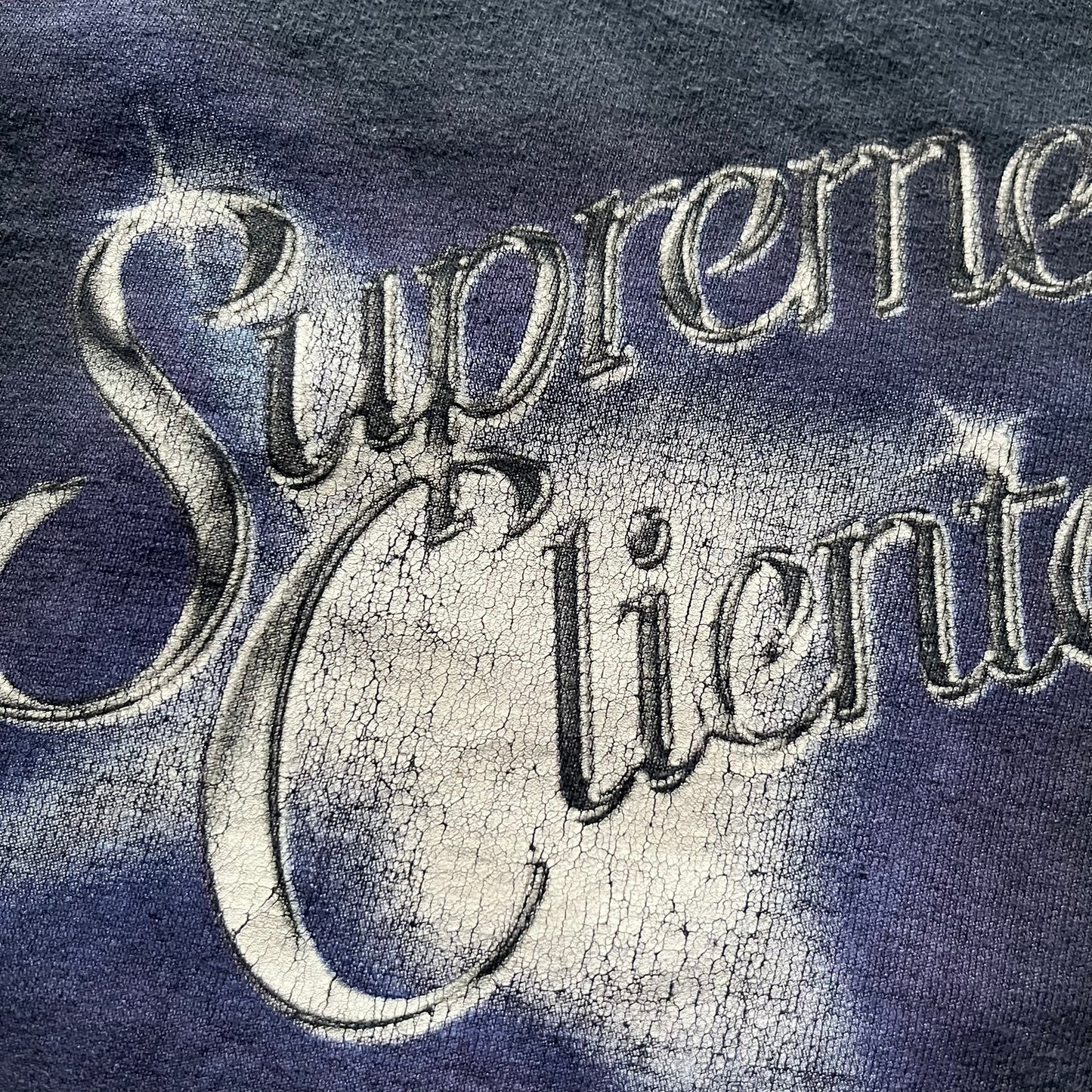 Supreme Clientele FW20 Navy Tee released in October 2020 as part of Supreme’s Fall/Winter 2020 collection. This cotton tee pays tribute to Ghostface Killah’s 2000 album Supreme Clientele, featuring the album’s iconic title graphic on the front and full tracklist on the back. A standout Supreme graphic tee that merges streetwear with hip-hop history.