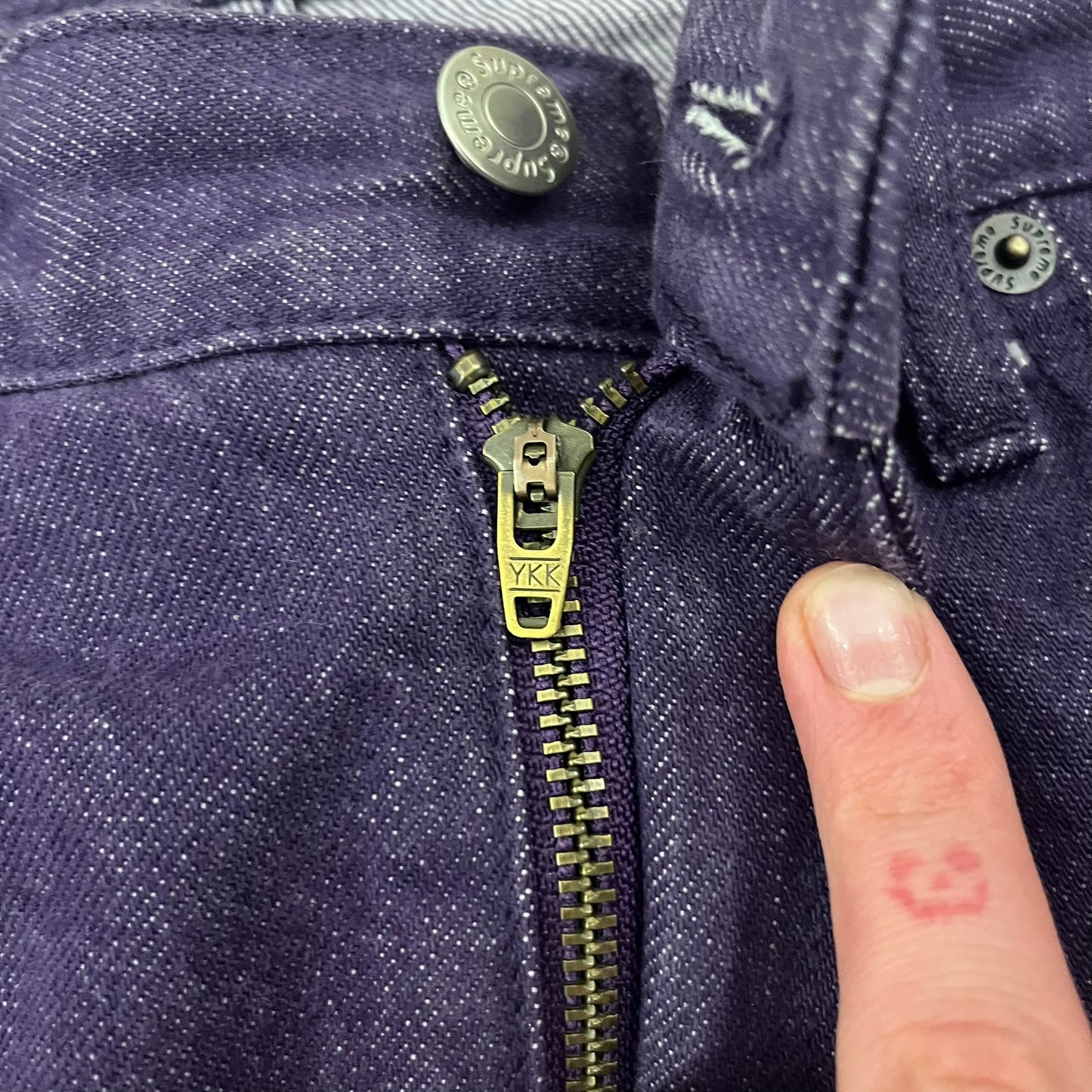 Supreme Denim Purple SS25 Baggy Shorts crafted from 13 oz. all-cotton denim in a purple hue. Features a relaxed baggy fit, classic five-pocket styling, zip fly, copper oxide rivets, and embroidered Supreme New York logo on the back pocket. Durable, stylish, and perfect for everyday streetwear.