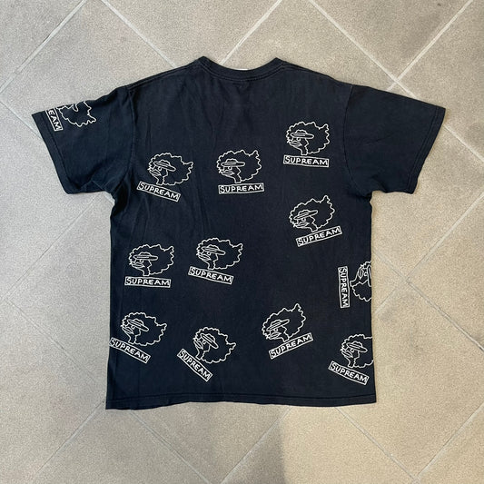 Supreme FW17 Gonz Heads Tee is a black T-shirt from the Fall/Winter 2017 collection created in collaboration with Mark Gonzales (The Gonz). The tee features repeated white Gonz head graphics printed across both the front and back in different orientations. The shirt is made in the USA.