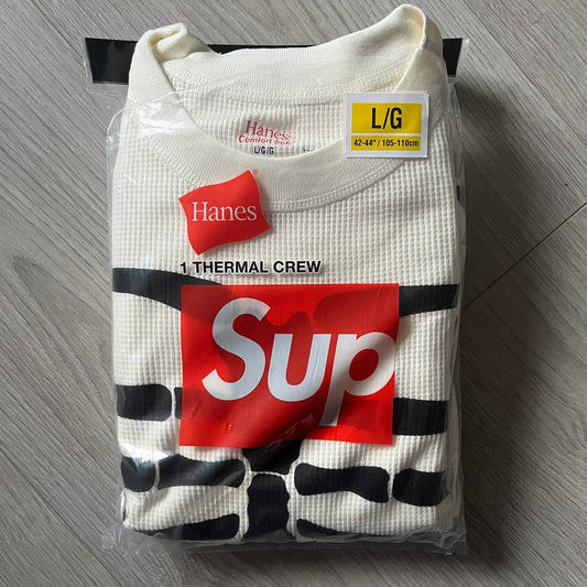 Supreme Hanes Bones Thermal Crew from FW25, crafted from 100% cotton in natural/white with black bone graphics. Features a ribcage-inspired skeleton print on the front, matching arm bone designs on the sleeves, and a small Supreme logo near the hem. Released on October 23, 2025.