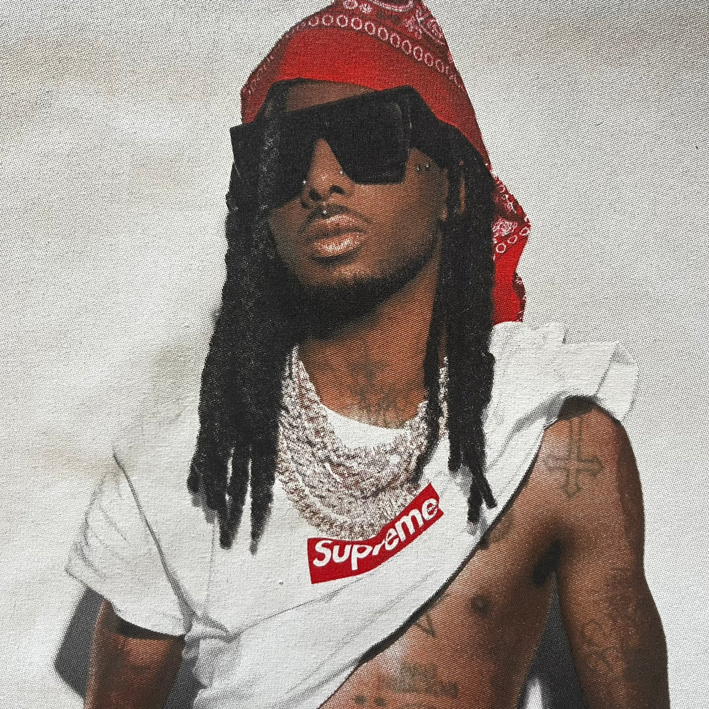 Supreme Playboi Carti photo tee in Heather Gray from the FW25 collection, featuring a large front print of the influential rapper. Crafted from soft cotton, it merges Supreme’s iconic photo tee format with Carti’s distinct cultural presence.