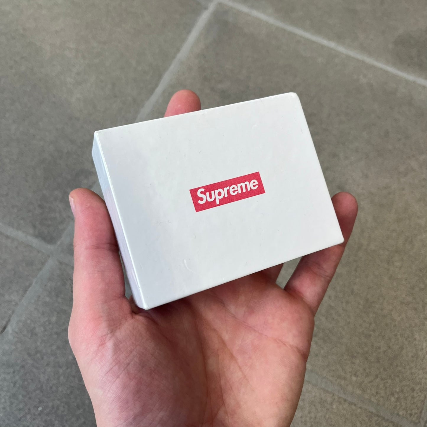Supreme SS18 Hair Bobbles (Set of 2) features clear acrylic dice-shaped pieces with small red Supreme Box Logo details inside, attached to black elastic bands. The set includes two hair bobbles and comes in the original white Supreme box. Released on May 17, 2018.