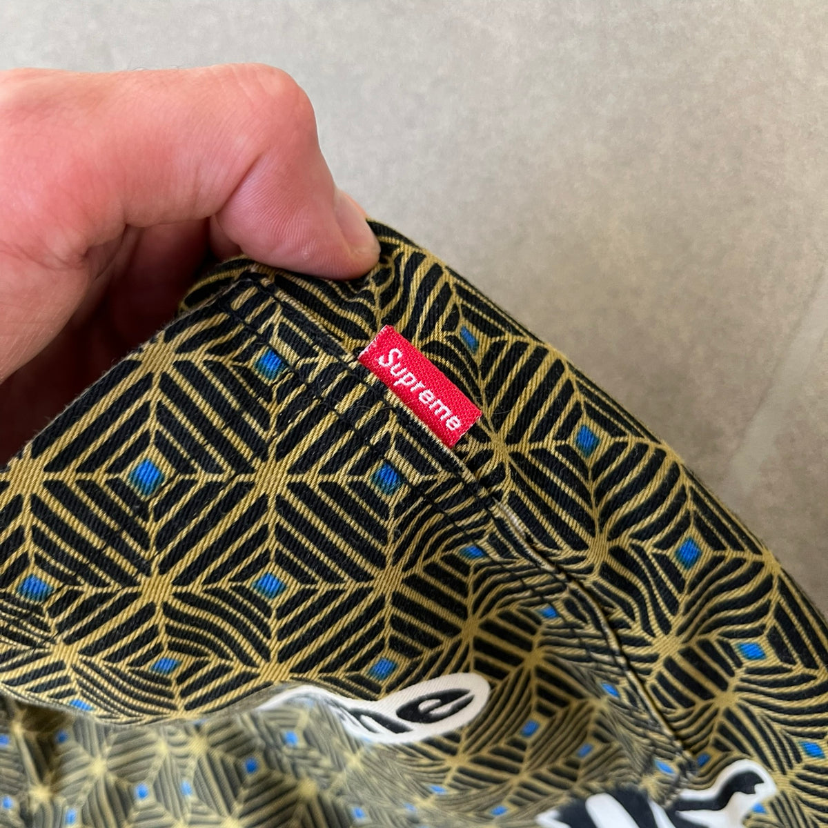 Supreme SS2017 Obama Green Pants are green/olive pants with the all-over patchwork print incorporating Barack Obama’s face, the words “Barack Obama,” and scattered Supreme logos. The design pays homage to the “khanas,” vibrant patterned garments with political graphics made by local designers in Ghana to commemorate the former president’s 2009 visit. They have two front pockets and one back pocket.