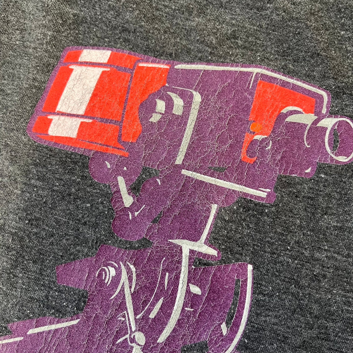 Team Fortress 2 “Balloonicorn & Sentry” 2010s Tee is a dark grey cotton-polyester blend T-shirt with a printed Valve neck tag. The front features a pink Balloonicorn graphic, while the back displays a red Engineer Sentry graphic. This officially licensed Team Fortress 2 T-shirt is a rare release.