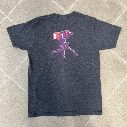 Team Fortress 2 “Balloonicorn & Sentry” 2010s Tee is a dark grey cotton-polyester blend T-shirt with a printed Valve neck tag. The front features a pink Balloonicorn graphic, while the back displays a red Engineer Sentry graphic. This officially licensed Team Fortress 2 T-shirt is a rare release.