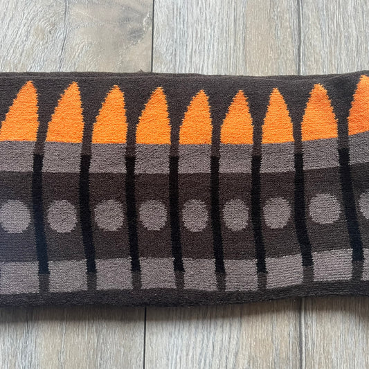 Officially licensed Team Fortress 2 merchandise released in 2014 by The Coop. This scarf is made from soft knit material and features a trompe-l’œil bullet bandolier graphic designed to replicate the ammunition belt worn by the Heavy character. Long and warm in construction, it displays repeated cartridge details along the length of the scarf.