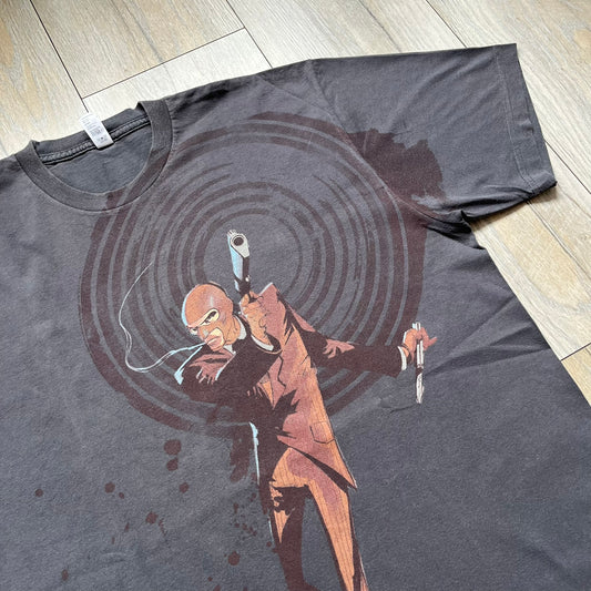 The Team Fortress 2 Red Spy 2010's Gray Tee is an official Valve shirt from the Sniper vs. Spy update, produced during Valve’s Amercian Apparel merch era. This charcoal gray tee features a red Spy character holding a butterfly knife and gun, set against a dark red target graphic with dripping effects. A super rare collectible, it represents one of the original Valve Store releases from over a decade ago.