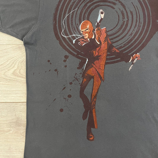 The Team Fortress 2 Spy 2009 Tee is an official Valve shirt from the Sniper vs. Spy update, produced during Valve’s in-house merch era before they switched to a different shirt company. This charcoal tee features a red Spy character holding a butterfly knife and gun, set against a dark red target graphic with dripping effects. A super rare collectible, it represents one of the original Valve Store releases from over a decade ago.