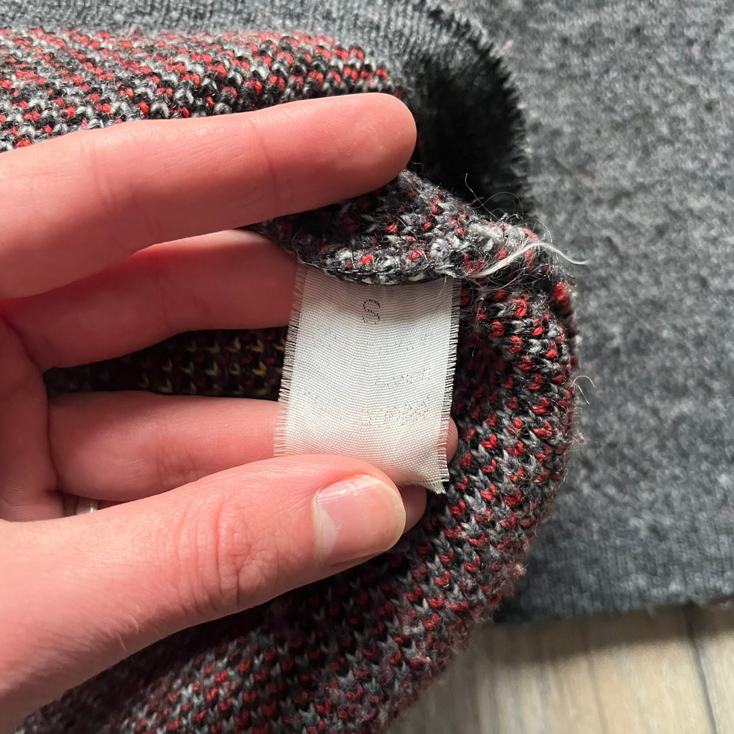 The Simpsons “Bart Freestyle” 2003 Knit Sweater is a gray knit featuring a large woven graphic of Bart snowboarding on the front, with “Bart” text placed below the character. On the back, in the same position as the front graphic, there is “Freestyle” text. It includes a Matt Groening The Simpsons 2003 FOX neck tag.