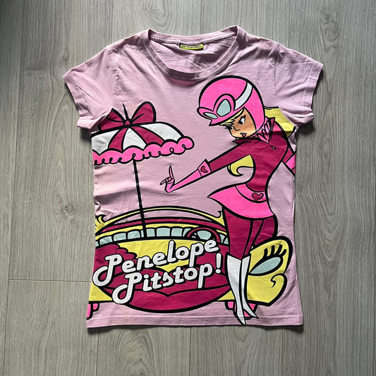 Baby pink 2013 Wacky Races women’s tee with Penelope Pitstop and her iconic "The Compact Pussycat" car. Glittery pink accents on her helmet, skirt, umbrella with white “Penelope Pitstop!” text. Officially Hanna-Barbera licensed.