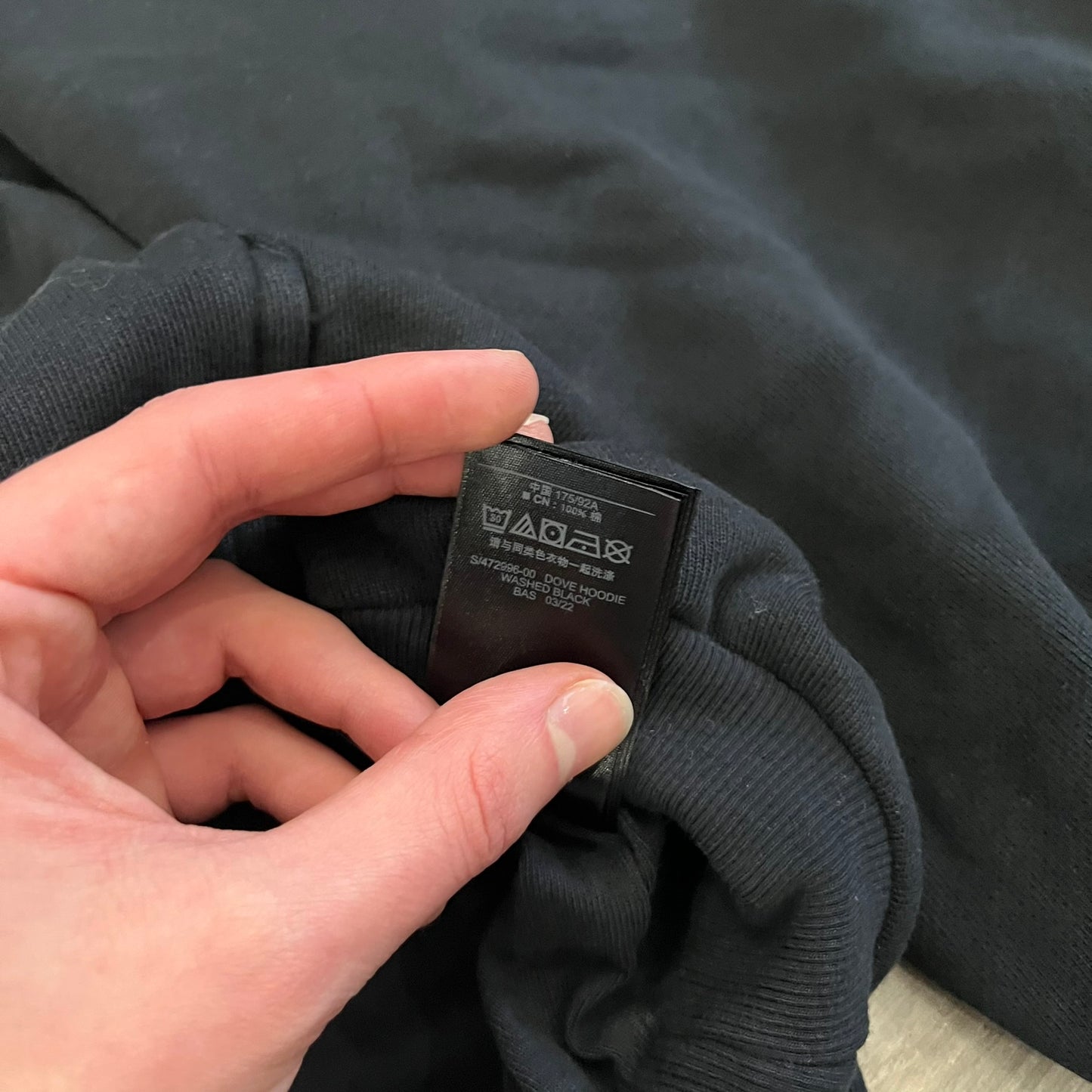 Yeezy GAP Engineered by Balenciaga Dove Hoodie in washed black, produced as part of the three-way Yeezy, GAP, and Balenciaga collaboration. Features a boxy, oversized fit with a slightly darker oversized GAP logo printed on the front and a large white dove graphic on the back. Each hoodie shows natural variation in wash, tone, and texture, consistent with the production process used for this release, from LosAngelesArchive.