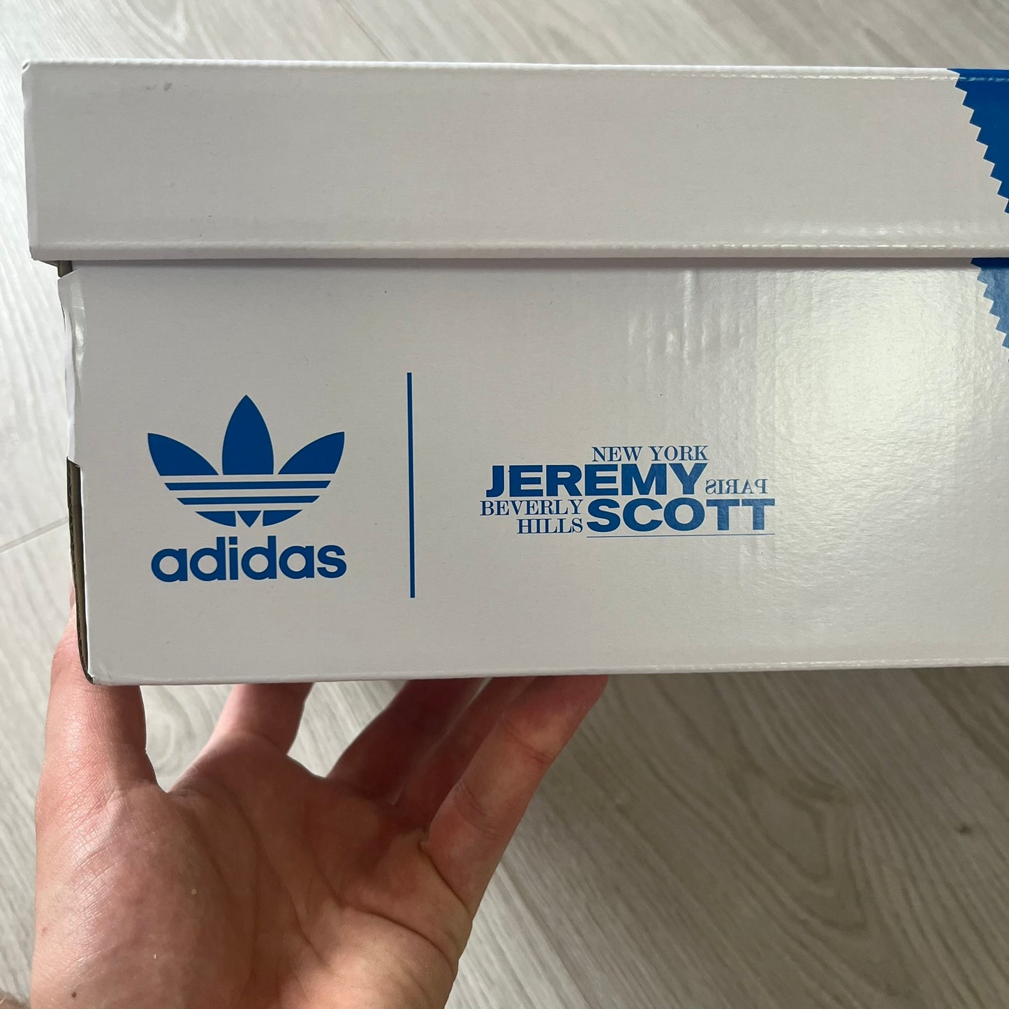 jeremy scott’s take on the adidas campus 80s includes black leather, serrated stripes, and unique faux fur tongues. detachable white bones on the laces add a customizable, standout touch. this 2023 release balances classic style with avant-garde details.