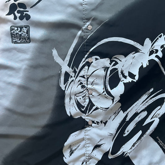 Close-up of a shirt with black and white abstract designs and a brand logo.