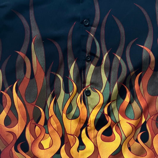 Black shirt with colorful flame pattern on a dark background