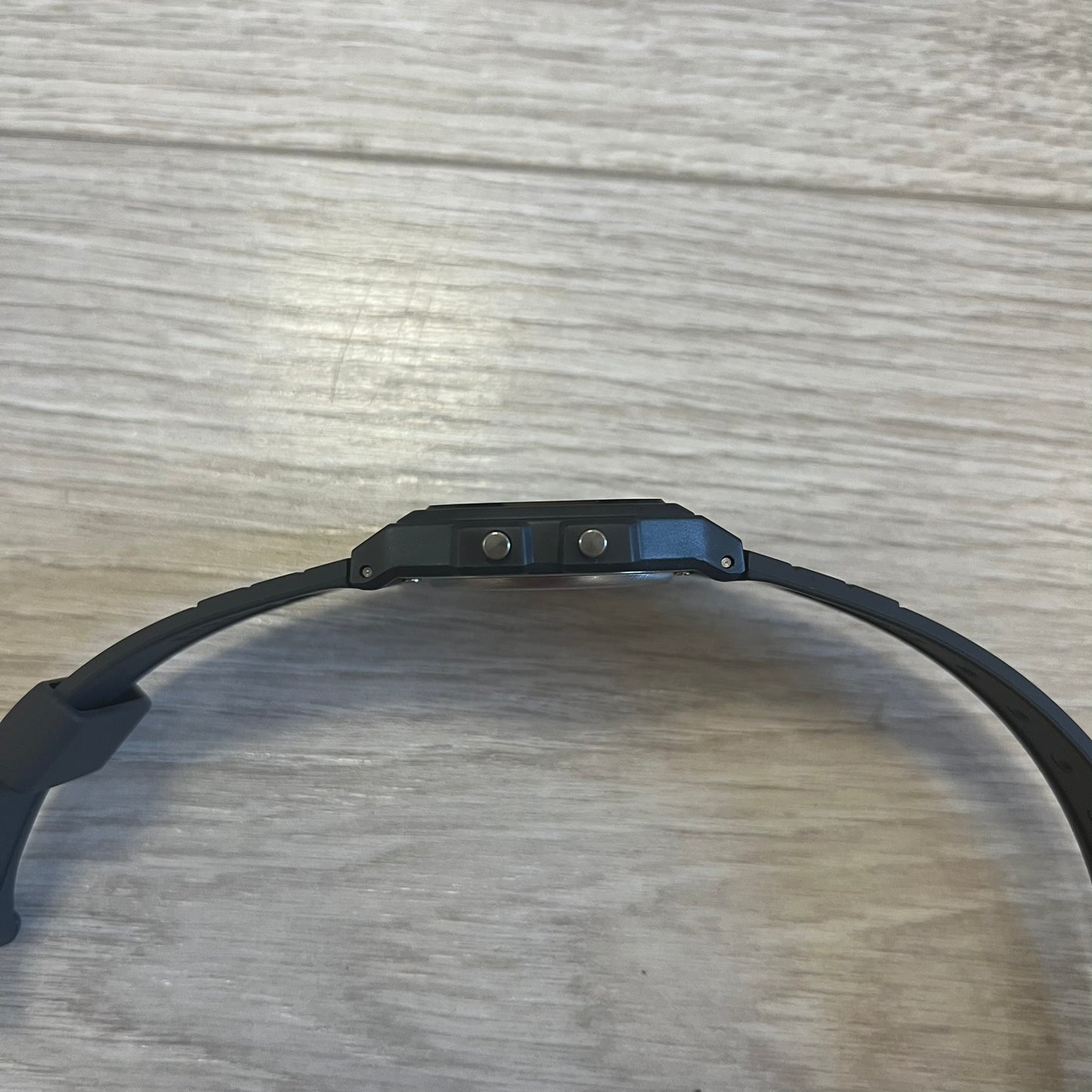 Black electronic device on a wooden surface