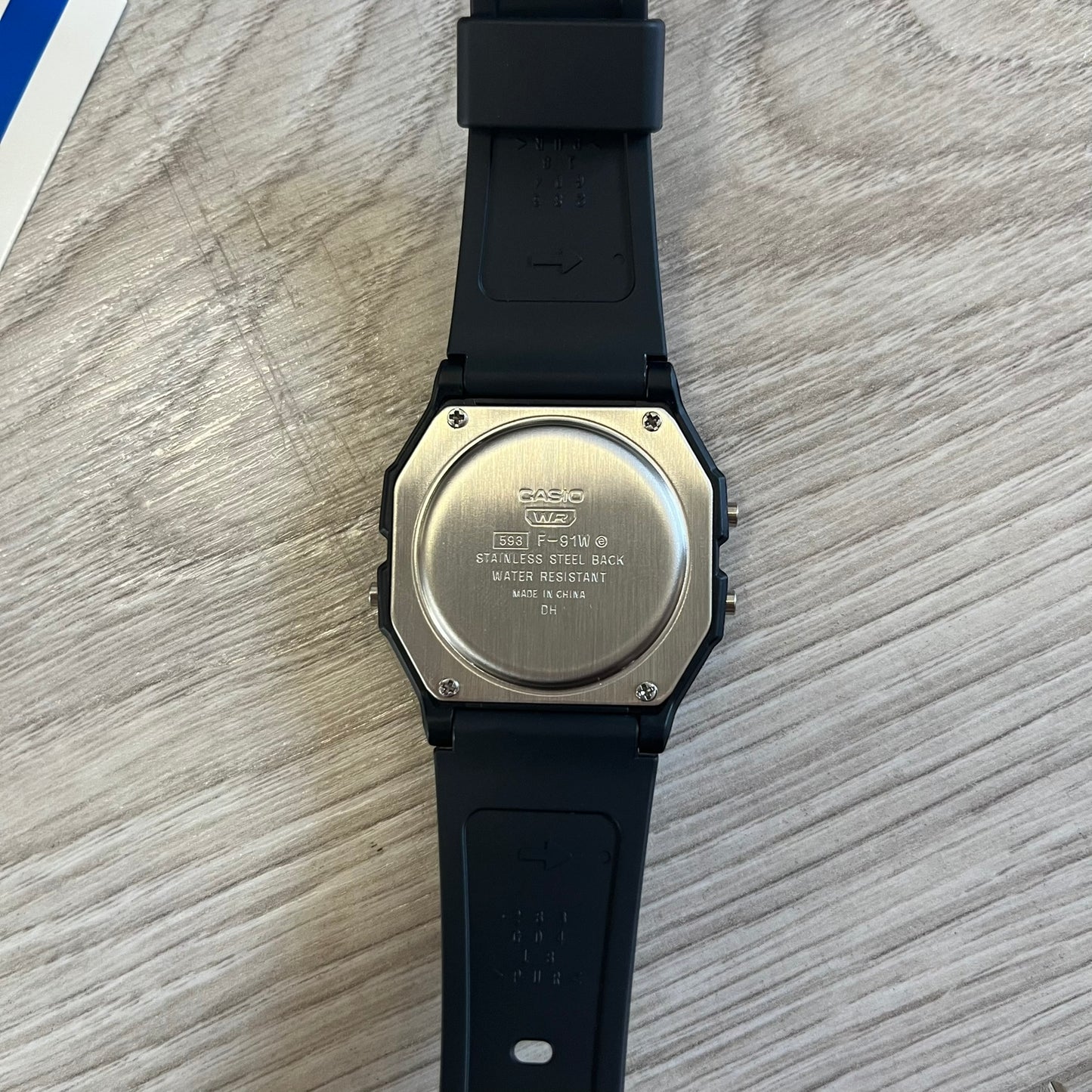 Back view of a Casio watch on a wooden surface