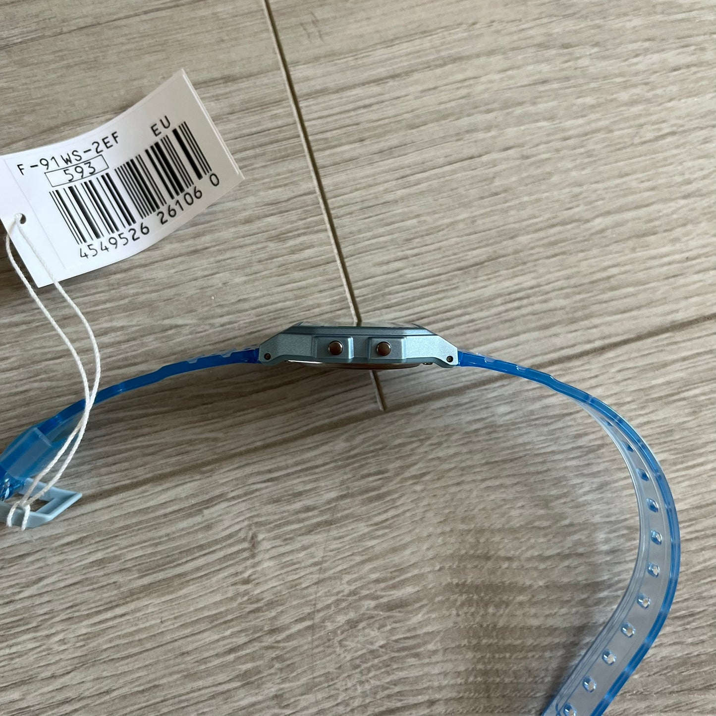 Blue plastic strip with metal component on a wooden surface